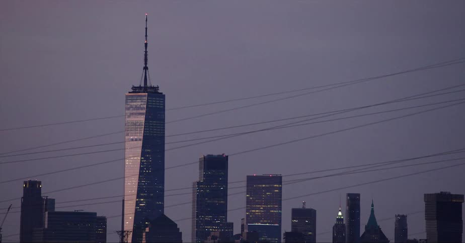 Aerial view of a downtown city during dusk is displayed