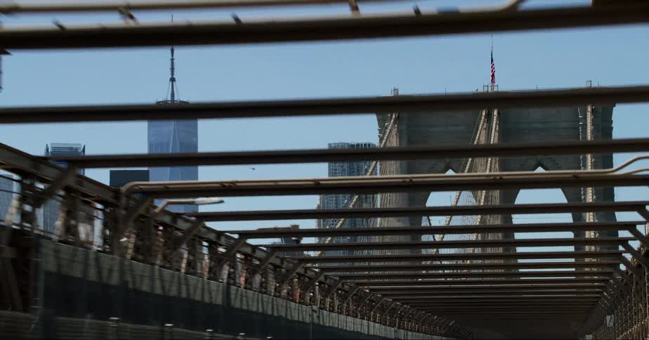 New york city skyline seen from the brooklyn bridge on a moving vehicle