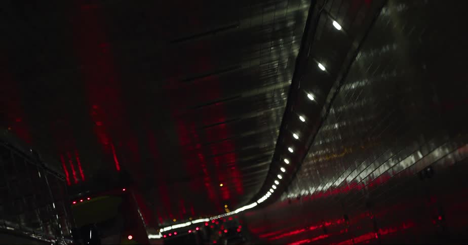 Vehicles driving through a tunnel at night