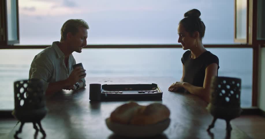 A couple play a board game at a restaurant
