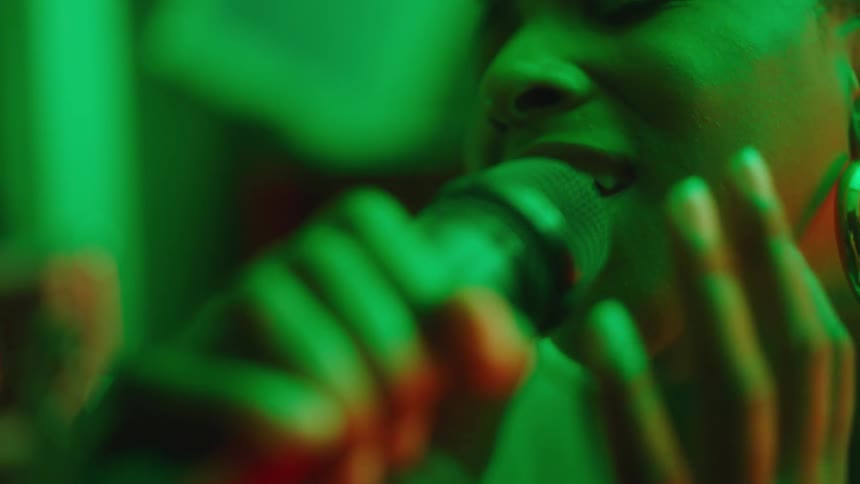 A woman is singing into a microphone