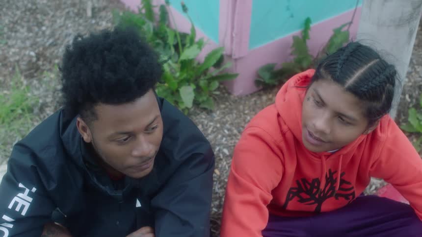 Two friends sit and laugh together