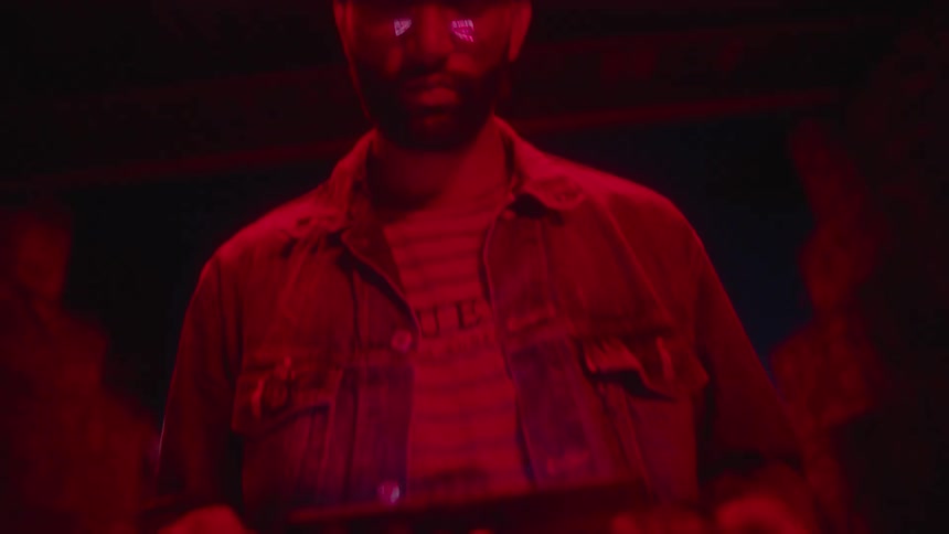 A man using a drone controller in a room