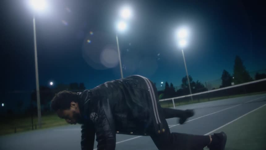 A man dancing outdoors at night