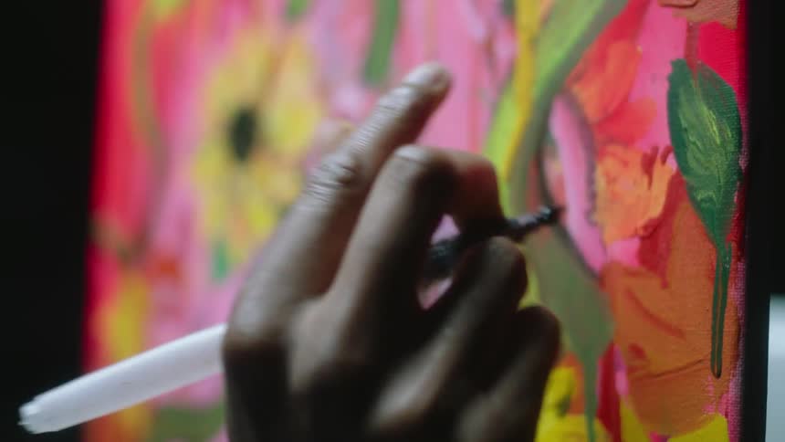 A womans hand as she paints a picture