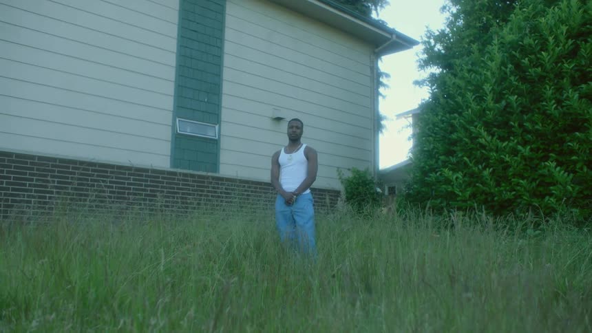 A man is standing outside in a suburban area