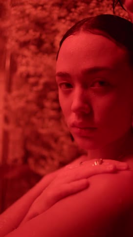 Woman stands near man under colored lighting
