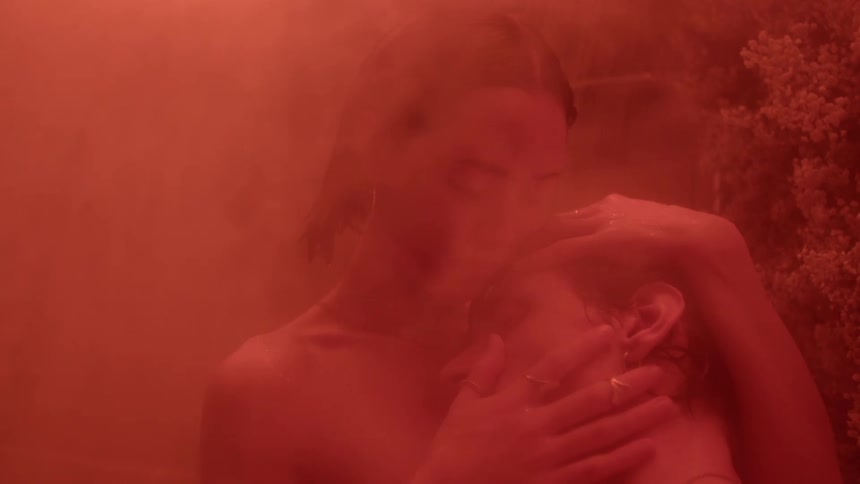 A woman is holding her boyfriends head in her hands as they embrace each other