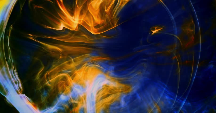 An orange flame like substance is moving as rings emerge and grow causing orange and blue to blend together