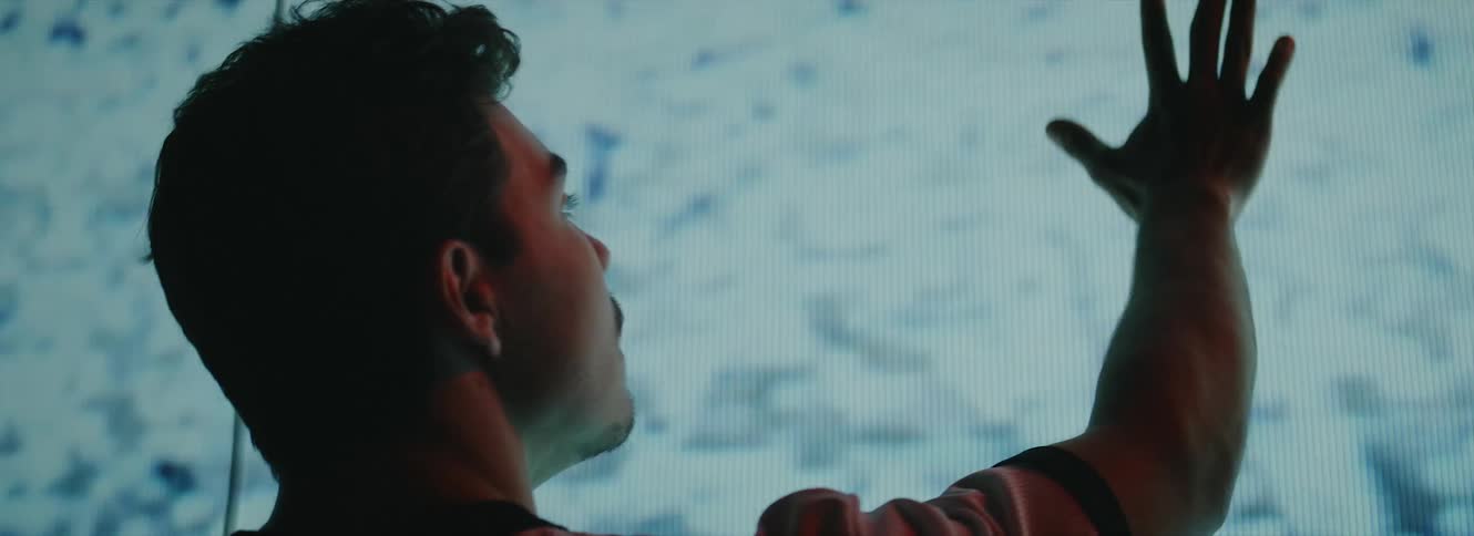 A man touches the large screen
