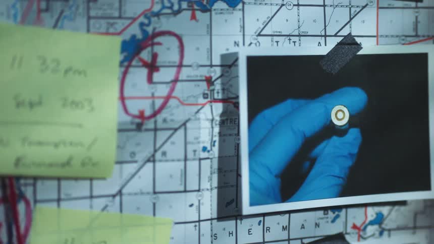 A photo of a gun shell on a board filled with crime scene evidence