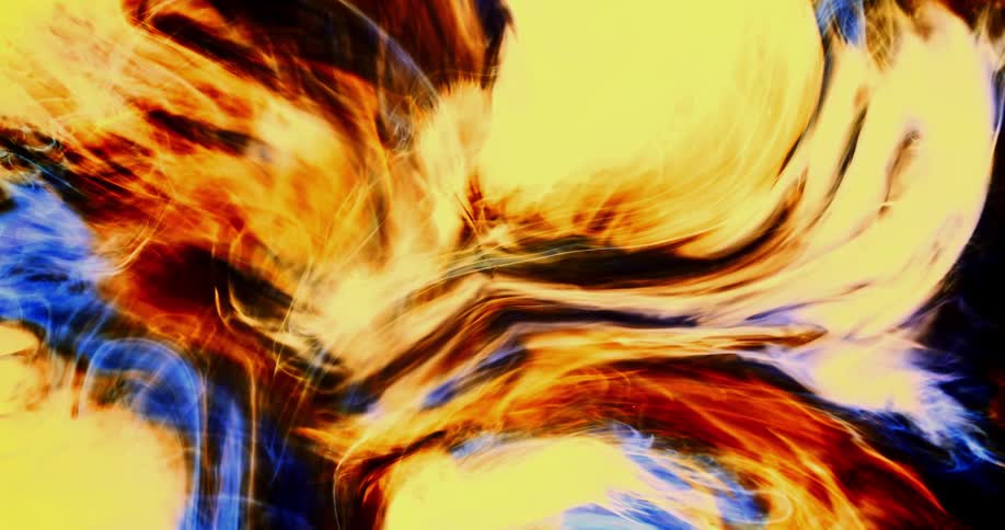A deep orange and yellow organic substance moves and blends together against a black background
