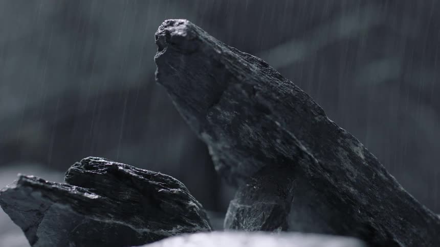 Rain pouring down on a rock that is slanted upwards