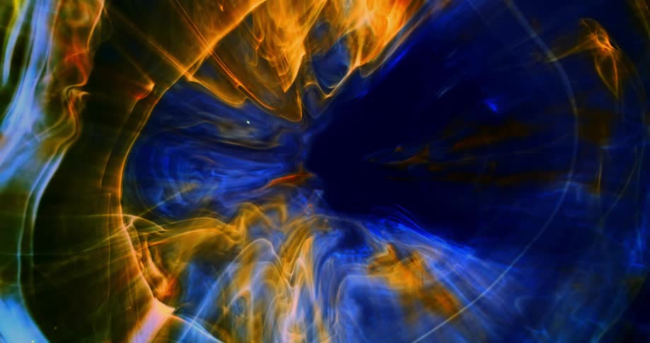 Computer graphics special effects of yellow and blue clouds and waves floating against a black background