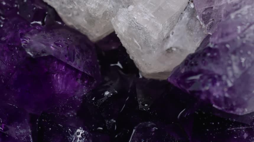 Purple and white crystal gems with water beaded on their surface