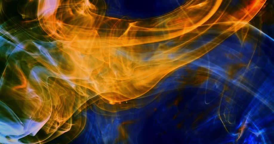 Glowing orange and electric blue wisps move in the darkness