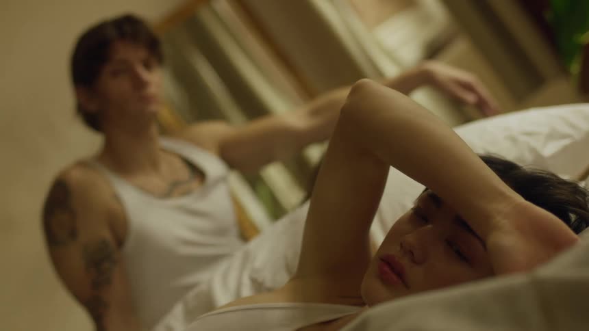 Two people are resting in bed
