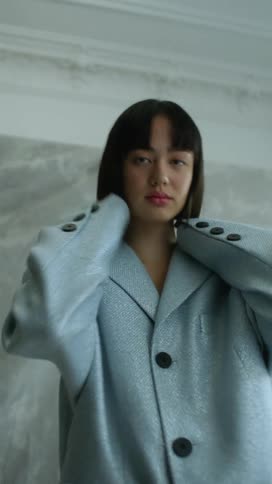 Woman poses in oversized jacket