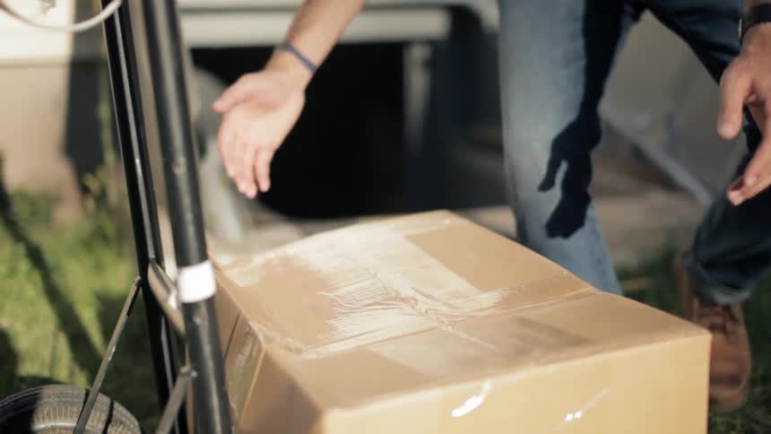Man taking a box down into a basement