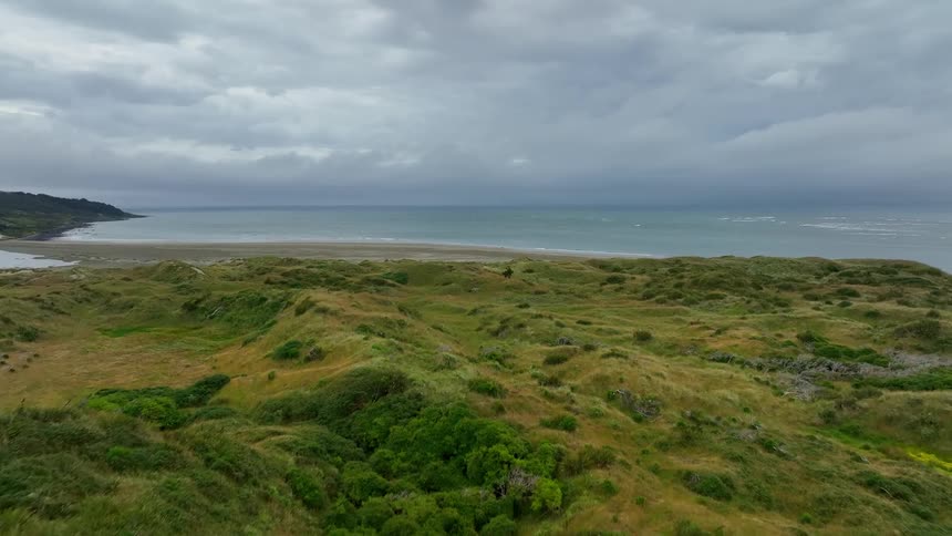 A grassland in front of the ocean