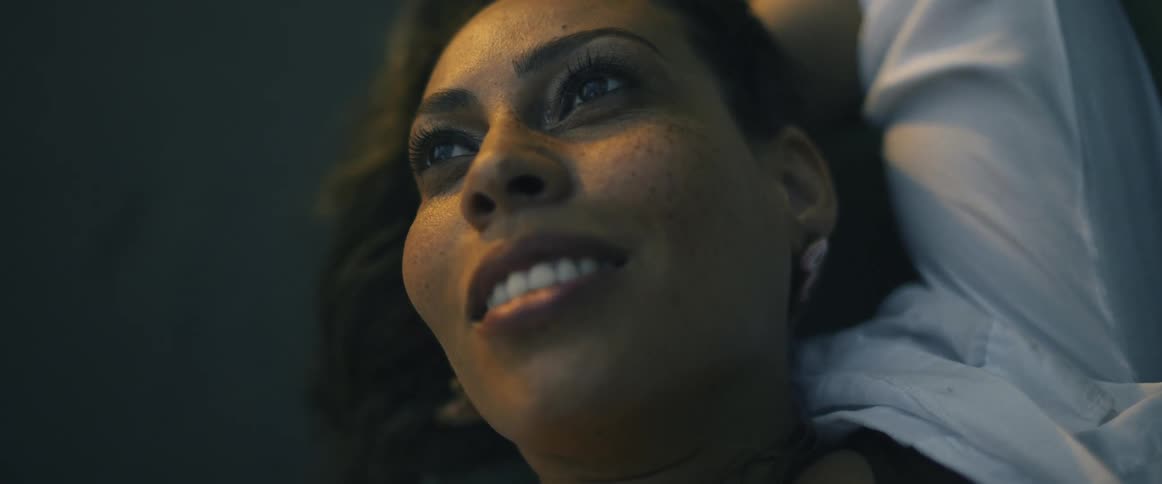 A woman lying down smiles