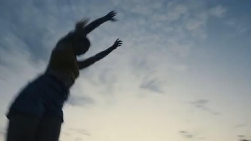 A woman doing a backflip outdoors