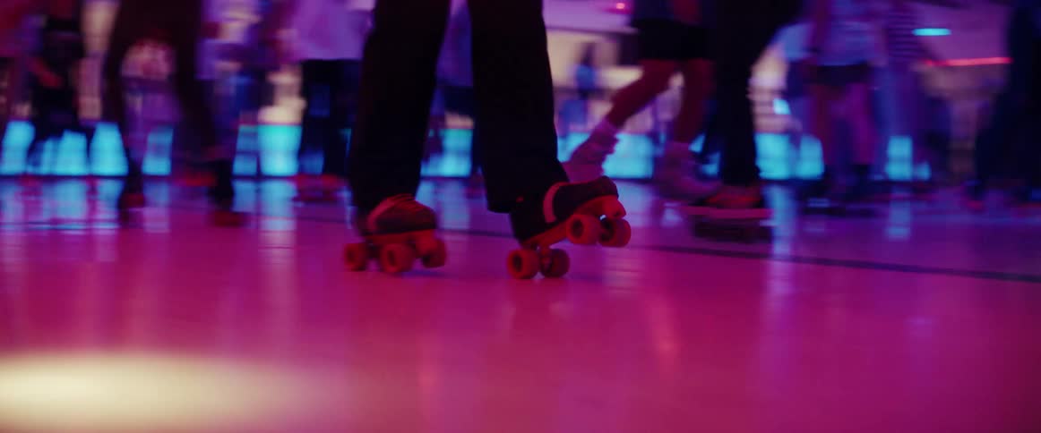 A group of people skating around a rink