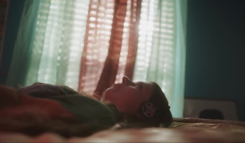 A woman laying in bed in the day
