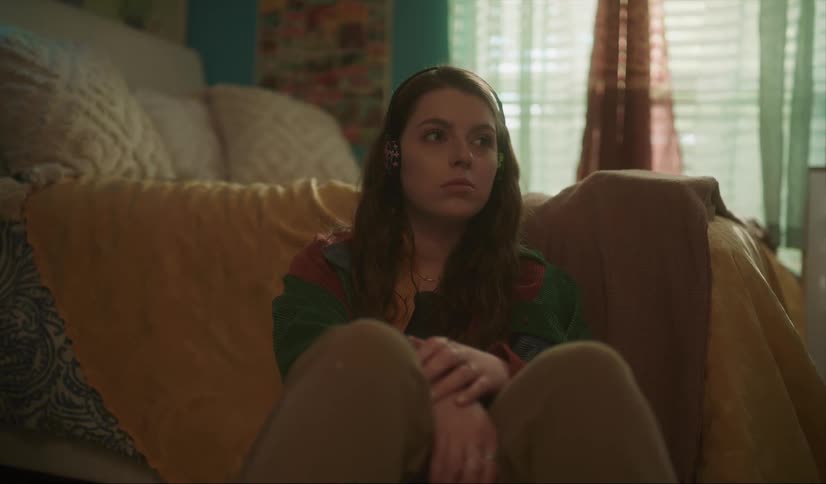 A woman sitting in a room thinking