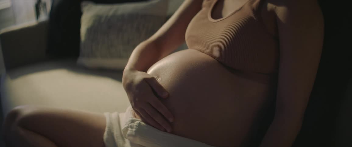 A pregnant woman sitting in a room