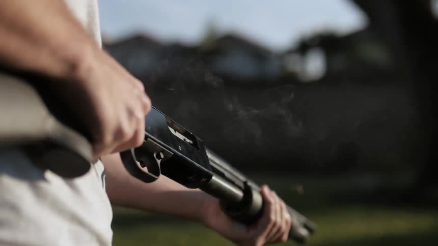 A man pumps a shotgun
