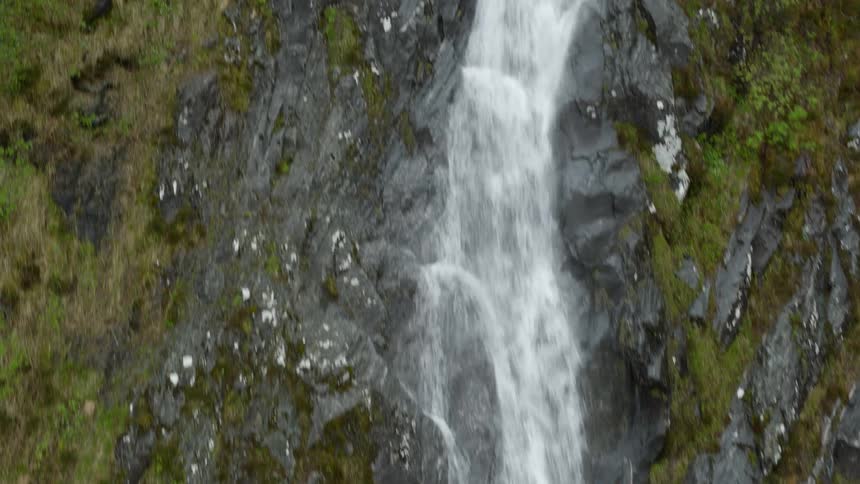 Waterfall cascades down cliffside in Norway