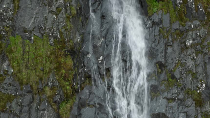 Waterfall cascades down cliffside in Norway