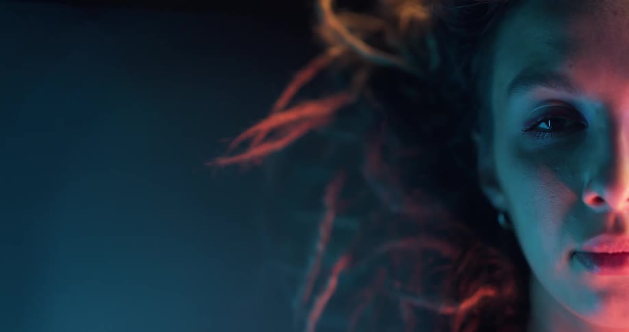 A woman is motionless as she stares straight ahead