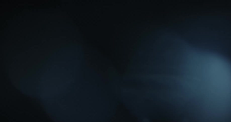 Light reflects on underwater bubbles as they rise to the surface