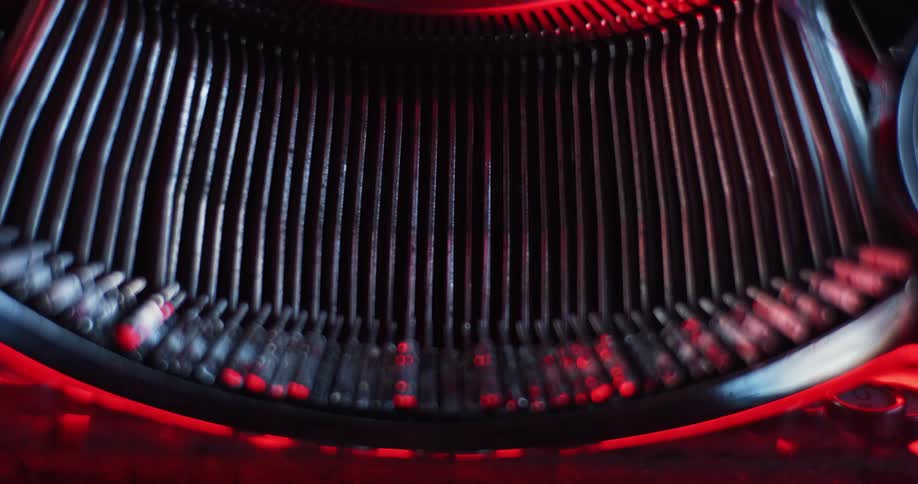 A traditional mechanical typewriter with metal typewriter hammers is being operated