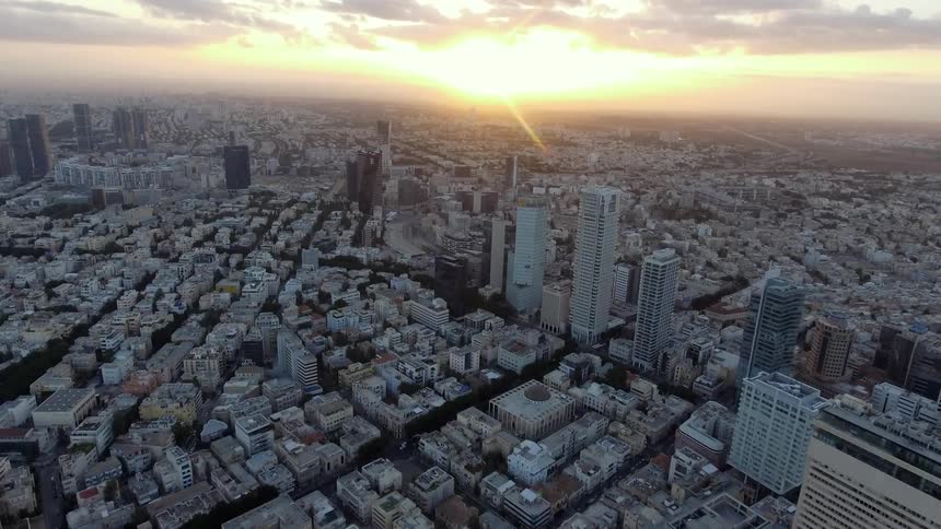 Aerial view of a large city at sunset