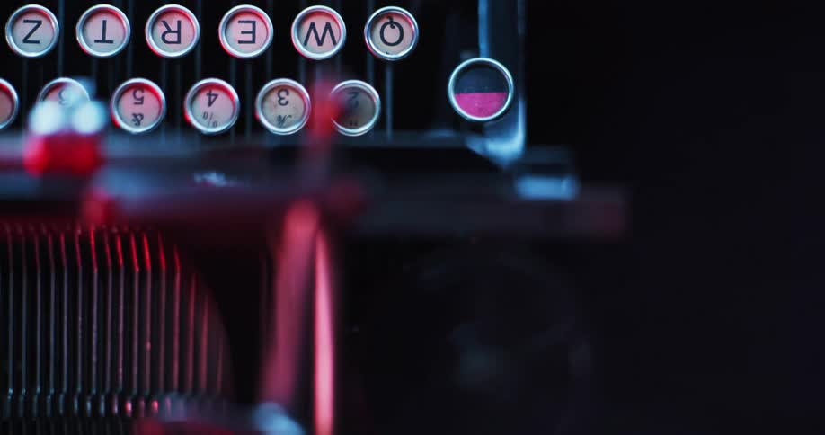 Lights are shining off an old typewriter at night