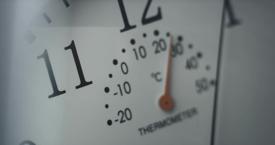 Arm of an antique analog clock moving over the dial