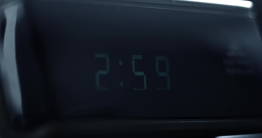 Digital alarm changing its time on the screen