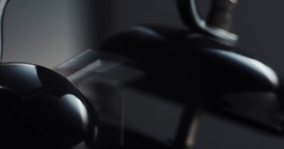 The small hammer of an alarm clock is dinging against the bell