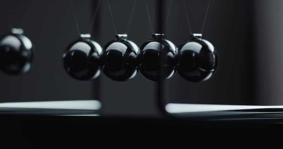 Spheres knock into each other and force the outer ones to swing away