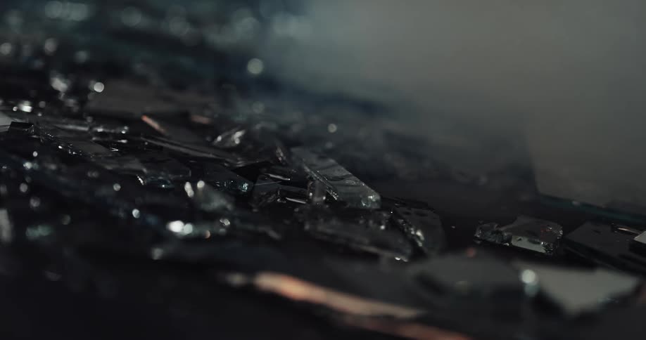 The ground is littered with fragments of broken glass at crime scene