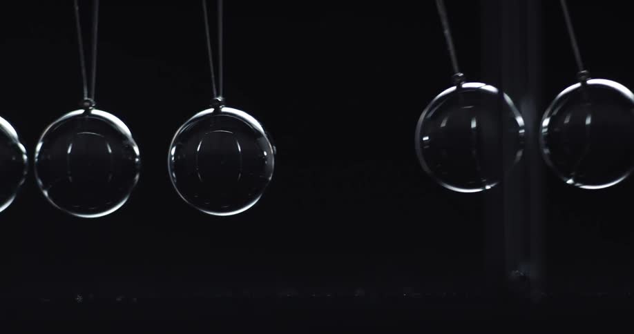 Hanging pendulum balls on a newtons cradle swing back and forth