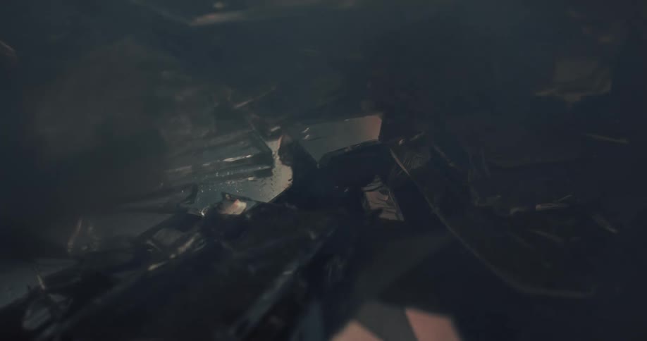 Smoke rolling over broken glass sprinkled with water on the ground of a dark room reflecting light