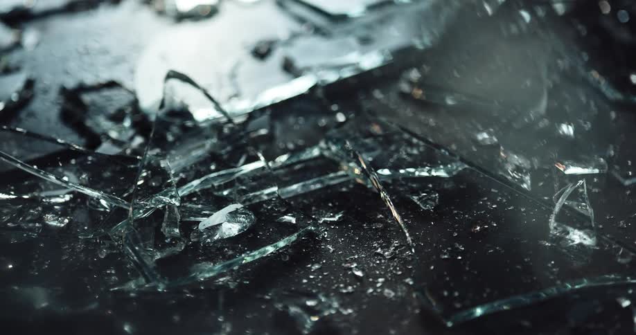 Light shines on shards of broken glass on the ground