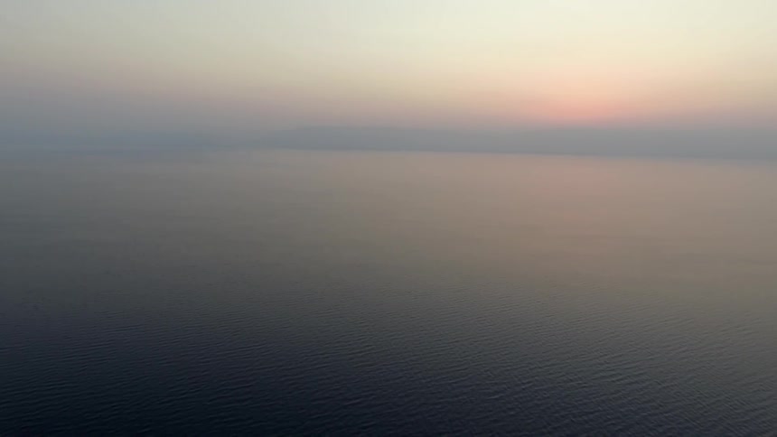 A body of water at sunrise