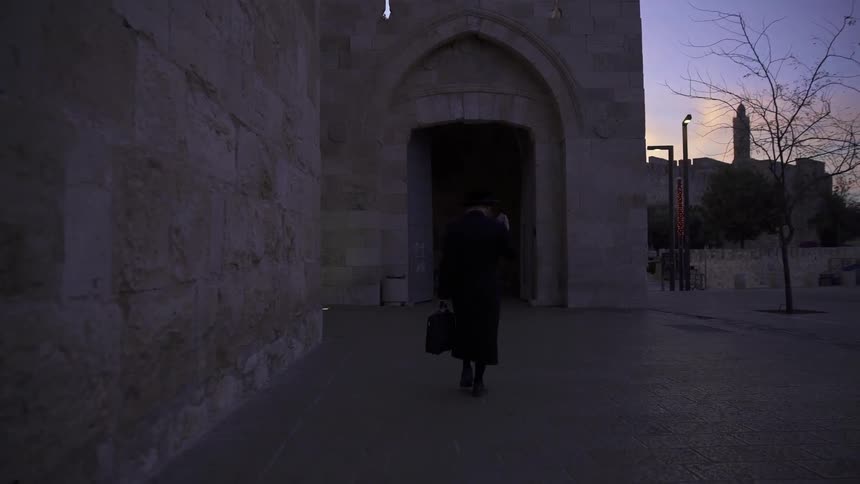 A man walks into a dark building