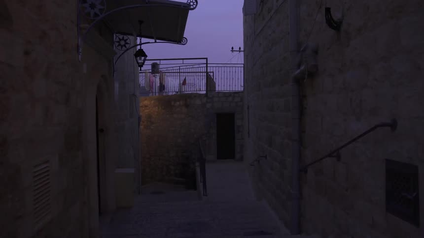 A twisting alleyway at dusk