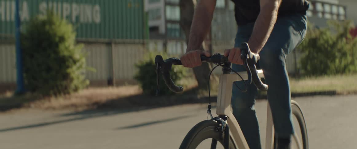 Man wearing casual clothing riding his bike in an empty street